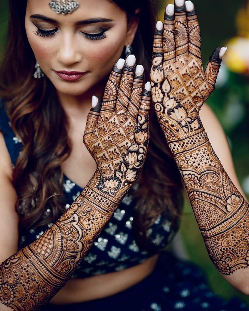 Beautiful woman showcasing elegant henna hand designs