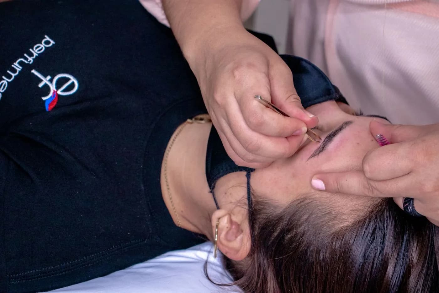 Close-up of eyebrow shaping and grooming in a professional studio