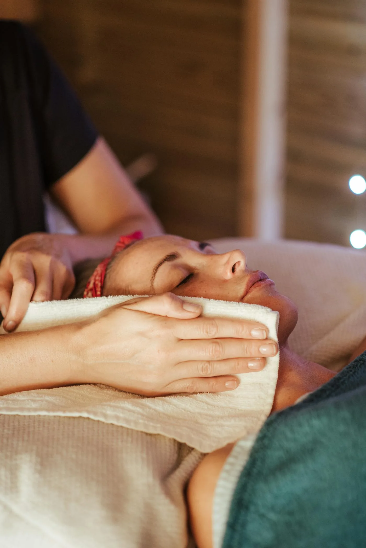 Client receiving a relaxing facial massage in a spa treatment room